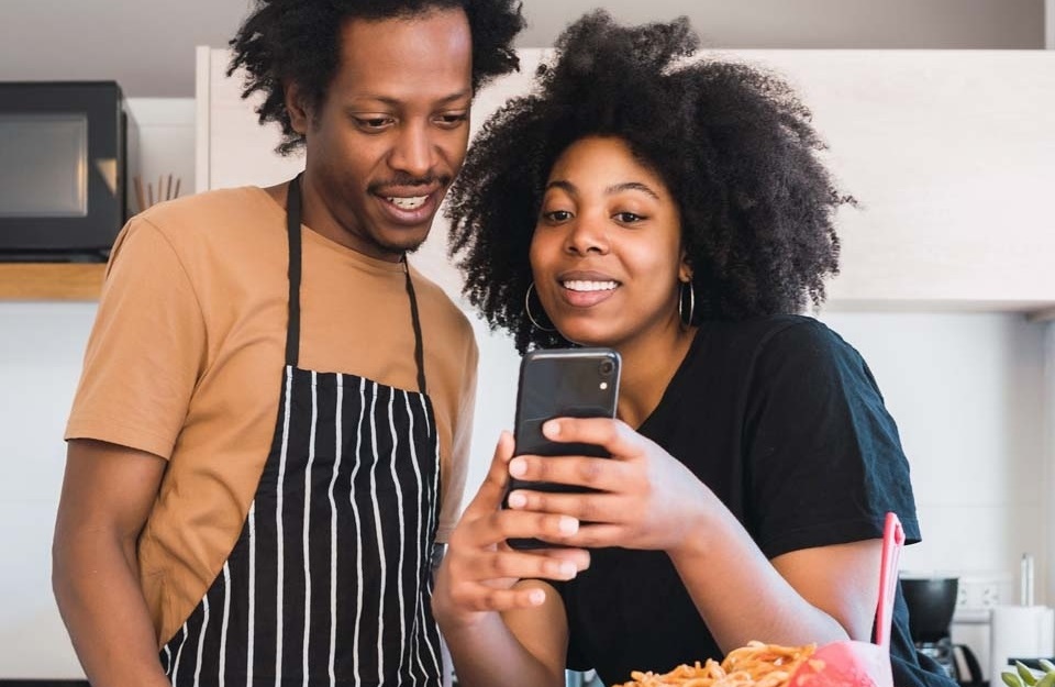 Two people looking at their phone