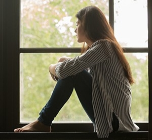 A woman looking out of a window.